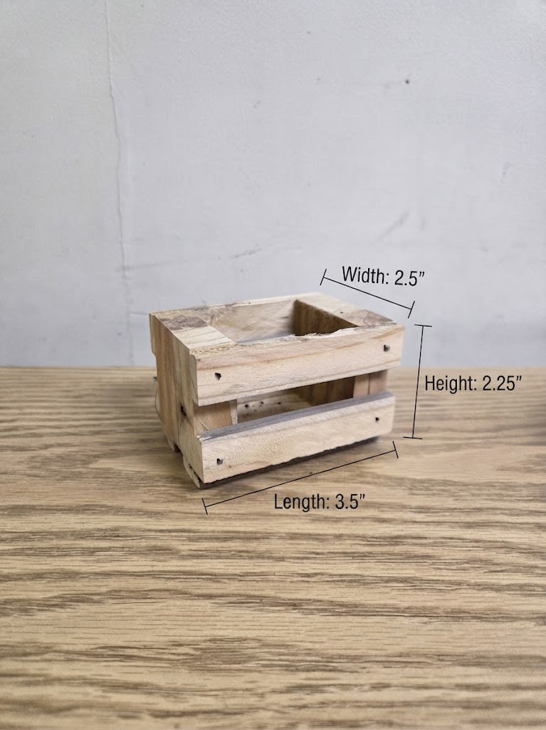 A small rustic wooden crate-style container made from pallet wood shown on a wood surface against a light wall, with overlaid dimension labels indicating width 2.5 inches, height 2.